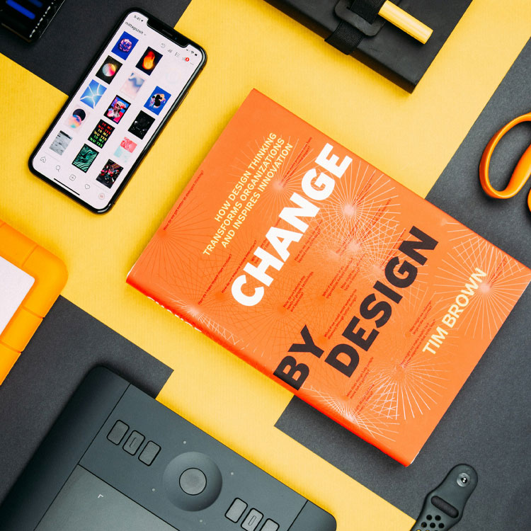 A picture featuring a graphic design book called Design by Change. 